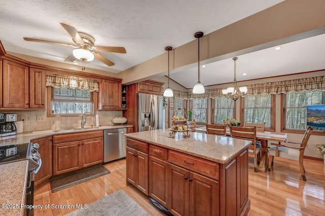 37 S Lehigh River Dr, Clifton Twp, PA 18424 - kitchen with appliances with stainless steel finishes, a sink, brown cabinets, a ceiling fan, and tasteful backsplash