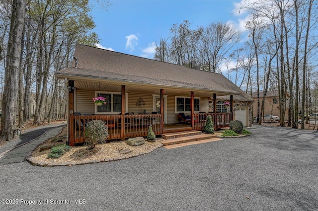 37 S Lehigh River Dr, Clifton Twp, PA 18424 - view of front of property with a porch, asphalt driveway, an attached garage, and roof with shingles
