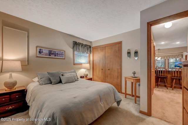 37 S Lehigh River Dr, Clifton Twp, PA 18424 - bedroom with light carpet, a closet, multiple windows, a textured ceiling, and baseboards