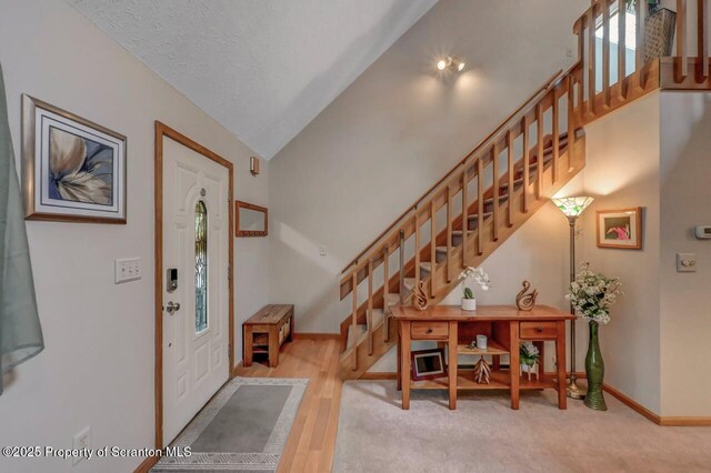 37 S Lehigh River Dr, Clifton Twp, PA 18424 - foyer entrance featuring stairway, baseboards, and high vaulted ceiling