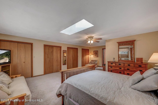 37 S Lehigh River Dr, Clifton Twp, PA 18424 - bedroom featuring a skylight, light colored carpet, multiple closets, and a ceiling fan