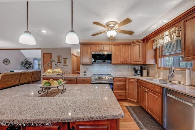 37 S Lehigh River Dr, Clifton Twp, PA 18424 - kitchen with appliances with stainless steel finishes, a sink, a ceiling fan, light wood finished floors, and decorative backsplash