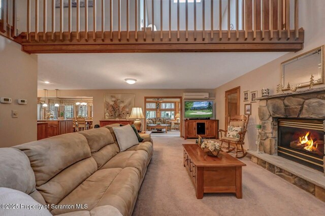 37 S Lehigh River Dr, Clifton Twp, PA 18424 - living area featuring light colored carpet, a fireplace, an AC wall unit, and a high ceiling