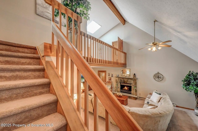 37 S Lehigh River Dr, Clifton Twp, PA 18424 - staircase with beamed ceiling, high vaulted ceiling, carpet floors, ceiling fan, and a stone fireplace