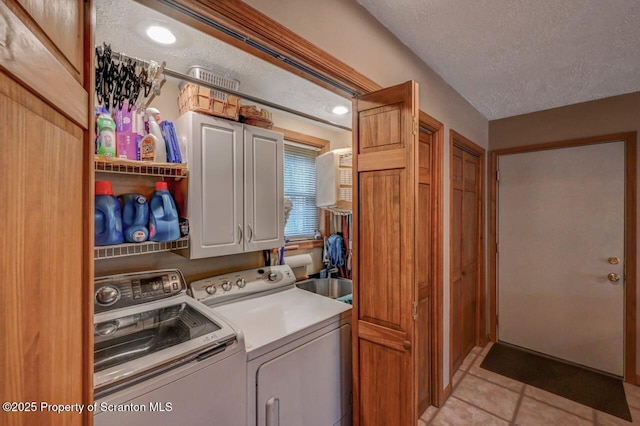 37 S Lehigh River Dr, Clifton Twp, PA 18424 - laundry room featuring cabinet space, washer and clothes dryer, light tile patterned floors, and a textured ceiling