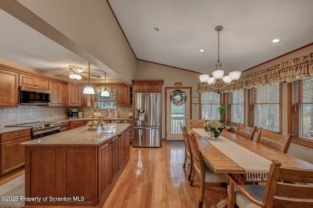 37 S Lehigh River Dr, Clifton Twp, PA 18424 - kitchen featuring stainless steel appliances, brown cabinetry, light wood finished floors, healthy amount of natural light, and vaulted ceiling