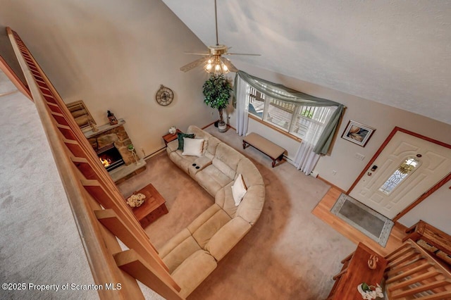 37 S Lehigh River Dr, Clifton Twp, PA 18424 - living area featuring carpet, a stone fireplace, a ceiling fan, and lofted ceiling