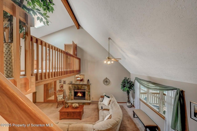 37 S Lehigh River Dr, Clifton Twp, PA 18424 - living area featuring beamed ceiling, a textured ceiling, a ceiling fan, carpet flooring, and a fireplace