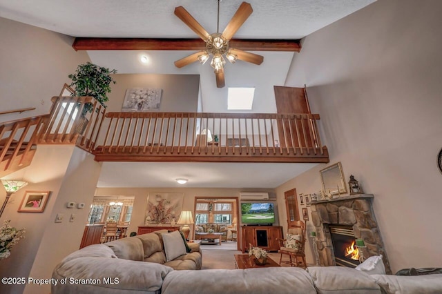 37 S Lehigh River Dr, Clifton Twp, PA 18424 - living room with high vaulted ceiling, a ceiling fan, beamed ceiling, a wall mounted AC, and a stone fireplace