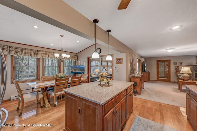 37 S Lehigh River Dr, Clifton Twp, PA 18424 - kitchen with brown cabinetry, a center island, light wood-style flooring, healthy amount of natural light, and vaulted ceiling