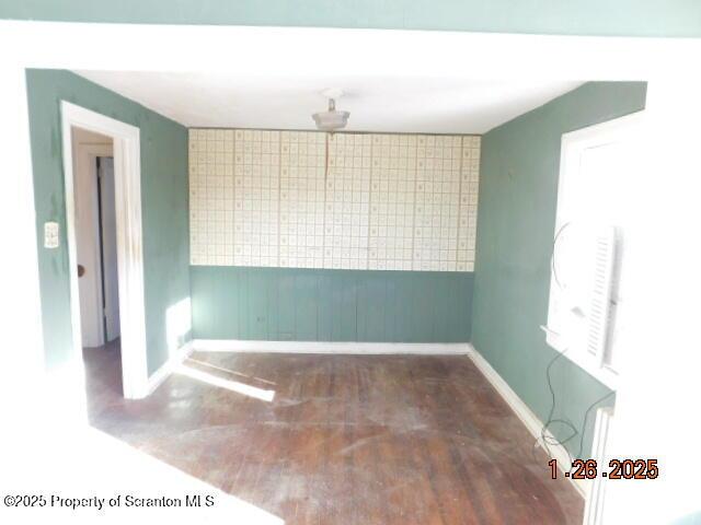 spare room with dark wood-type flooring