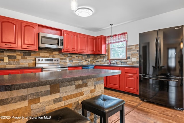 609 Landmesser Ave, West Hazleton, PA 18202 - kitchen with stainless steel appliances, light wood-style floors, dark countertops, and dark brown cabinets