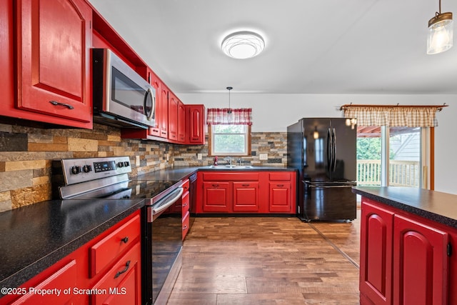 609 Landmesser Ave, West Hazleton, PA 18202 - kitchen featuring appliances with stainless steel finishes, dark wood-style floors, tasteful backsplash, and dark countertops