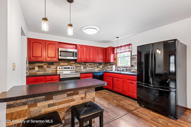 609 Landmesser Ave, West Hazleton, PA 18202 - kitchen featuring black appliances, tasteful backsplash, dark countertops, and dark wood-type flooring
