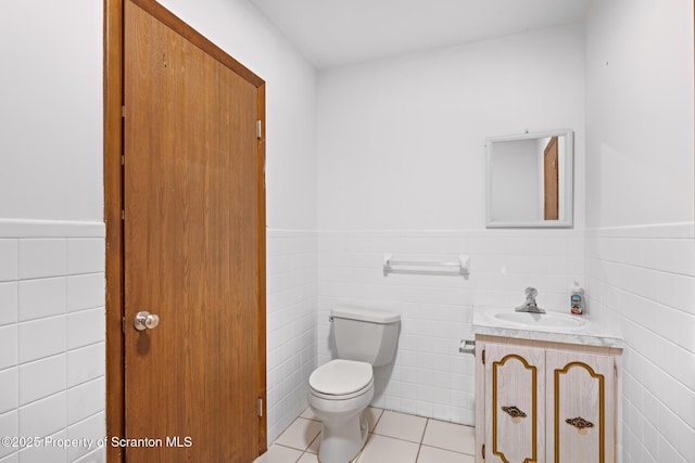 609 Landmesser Ave, West Hazleton, PA 18202 - bathroom featuring vanity, tile walls, a wainscoted wall, and tile patterned flooring