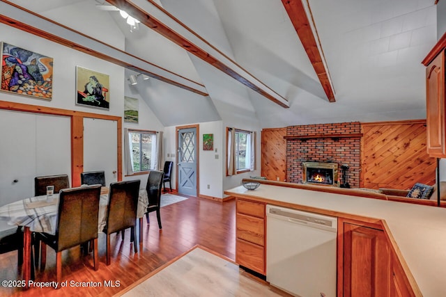 3222 Bluebird Dr, Bushkill, PA 18324 - kitchen with a fireplace, light wood-style flooring, open floor plan, light countertops, and white dishwasher