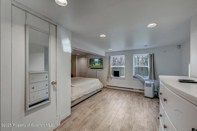 3222 Bluebird Dr, Bushkill, PA 18324 - bedroom featuring light wood-type flooring, a baseboard radiator, and recessed lighting