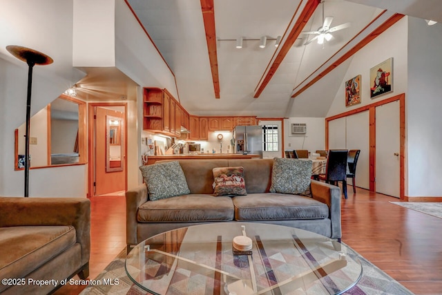 3222 Bluebird Dr, Bushkill, PA 18324 - living room featuring ceiling fan, light wood-style flooring, rail lighting, and high vaulted ceiling
