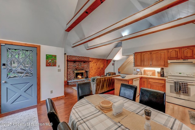 3222 Bluebird Dr, Bushkill, PA 18324 - dining area featuring wooden walls, beamed ceiling, and high vaulted ceiling