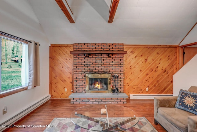 3222 Bluebird Dr, Bushkill, PA 18324 - living area with a fireplace, lofted ceiling with beams, baseboard heating, and wood finished floors