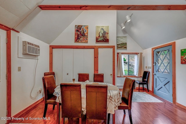 3222 Bluebird Dr, Bushkill, PA 18324 - dining area featuring vaulted ceiling, a wall mounted air conditioner, baseboards, and wood finished floors