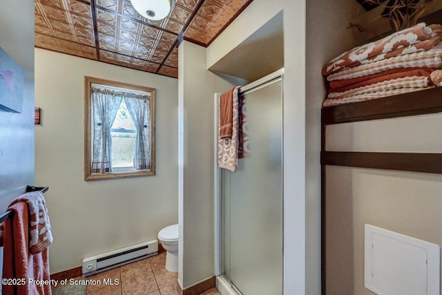 bathroom featuring walk in shower, toilet, a baseboard heating unit, and tile patterned floors