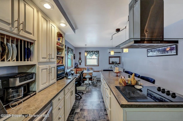 kitchen featuring black electric stovetop, cream cabinetry, decorative light fixtures, and ventilation hood