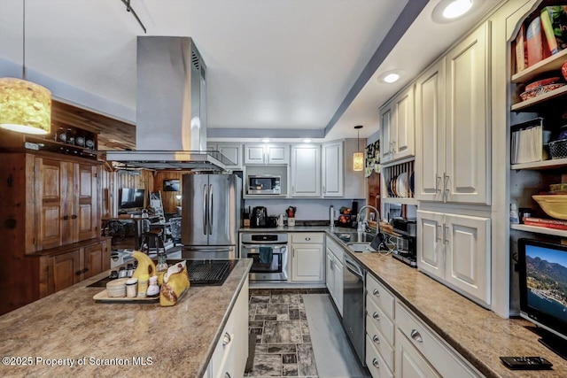 kitchen featuring stainless steel appliances, light stone countertops, island exhaust hood, decorative light fixtures, and sink