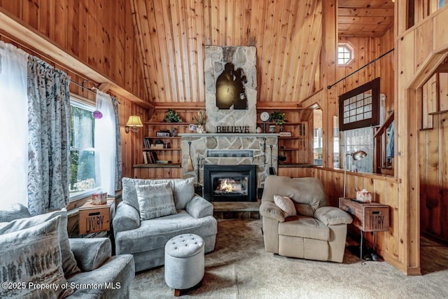 carpeted living room featuring high vaulted ceiling, wooden ceiling, wood walls, and a fireplace