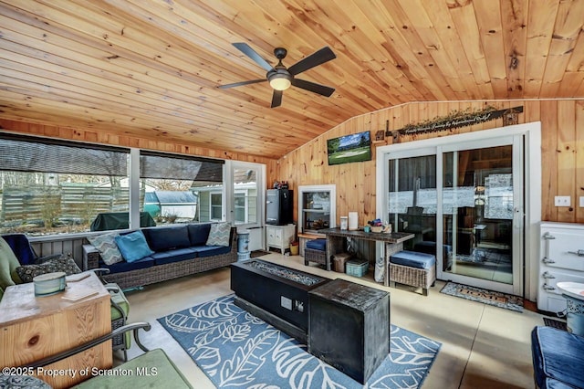 living room with ceiling fan, vaulted ceiling, wooden walls, and wooden ceiling