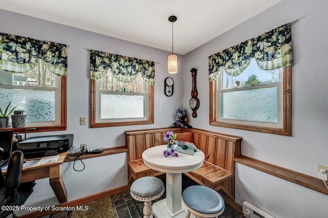 dining space with a baseboard heating unit