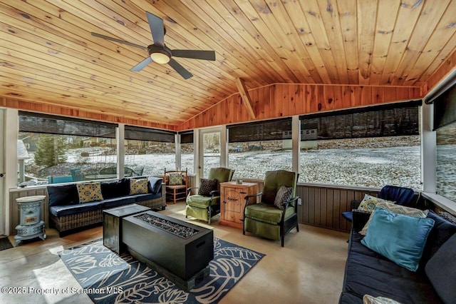 sunroom / solarium featuring vaulted ceiling, ceiling fan, and wood ceiling