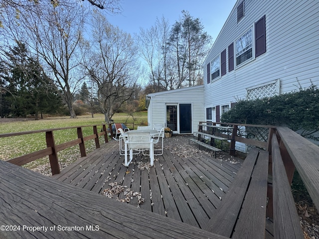 wooden deck featuring a yard