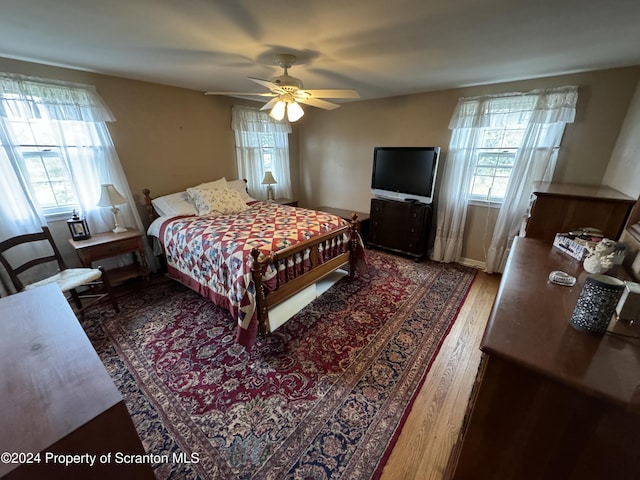 bedroom featuring dark hardwood / wood-style flooring and ceiling fan