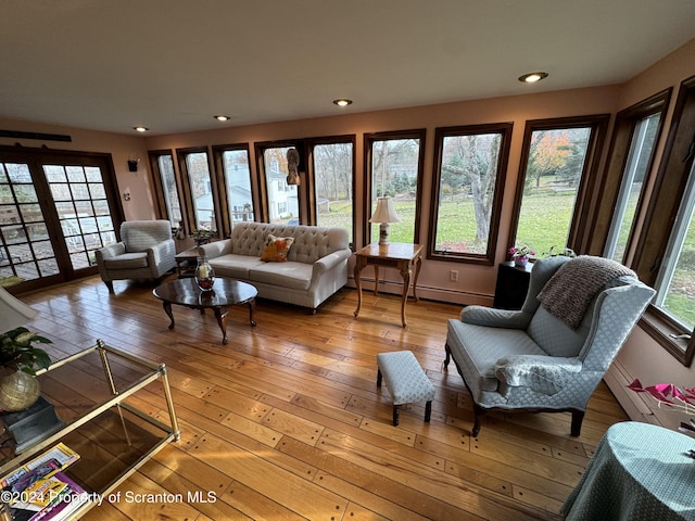 living room with hardwood / wood-style flooring and a baseboard heating unit