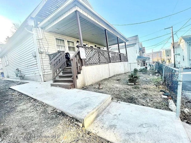 view of side of property featuring a porch