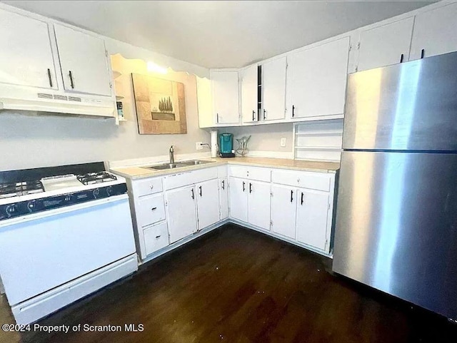 kitchen with white cabinets, stainless steel fridge, white range, and sink