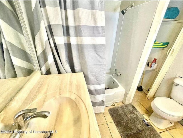 bathroom with toilet, shower / bath combination with curtain, and tile patterned floors