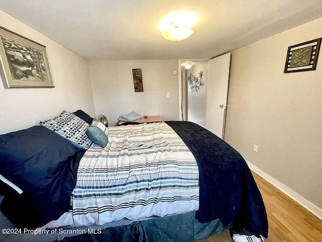 bedroom with hardwood / wood-style flooring