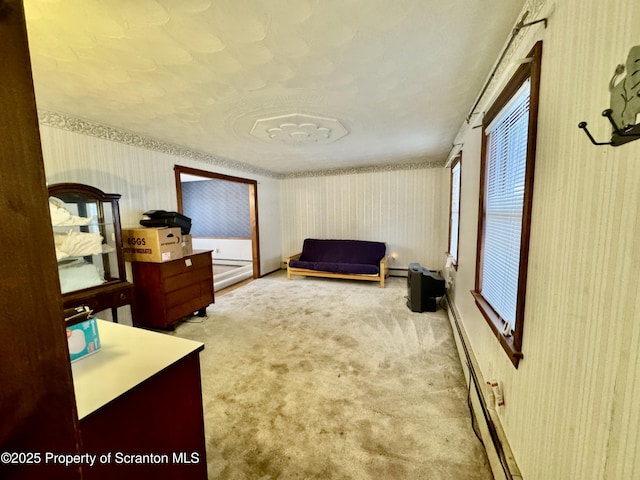 living area featuring light carpet and a baseboard radiator