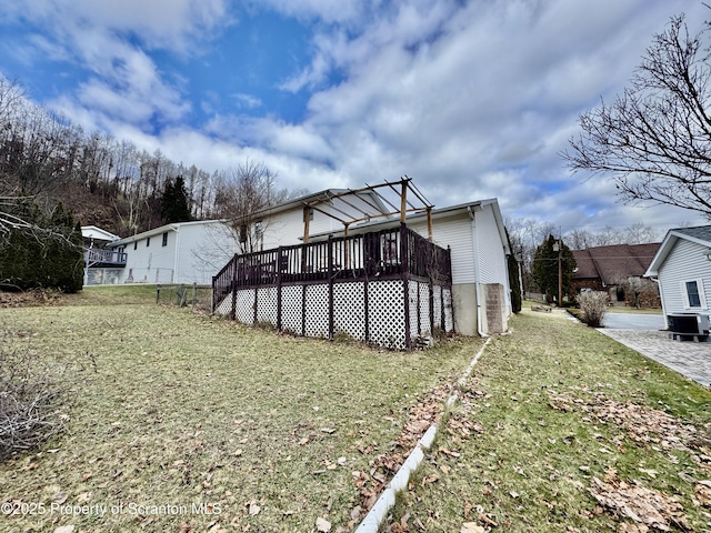 exterior space with central AC, a yard, and a deck