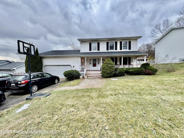 view of property with a front lawn, covered porch, and a garage