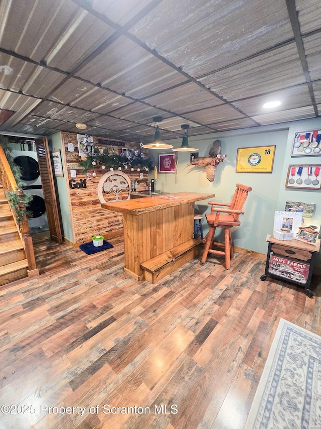 bar with hardwood / wood-style floors