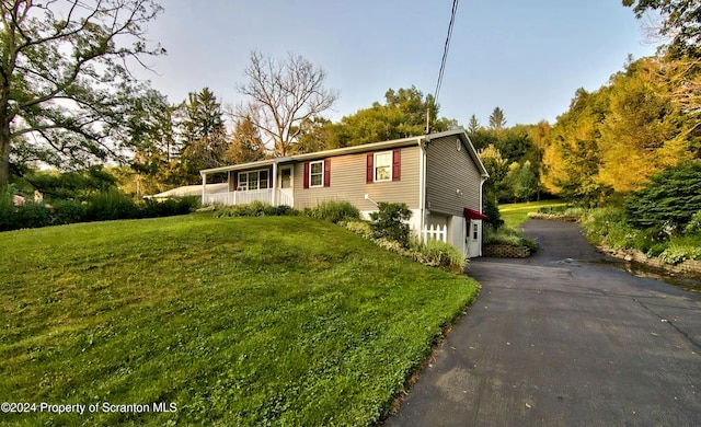 view of front of house with a front yard and covered porch