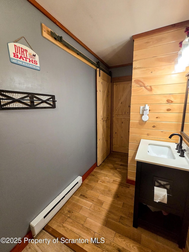 bathroom with vanity, hardwood / wood-style flooring, and a baseboard radiator