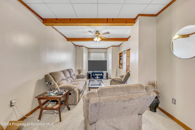 carpeted living room with a drop ceiling and ceiling fan