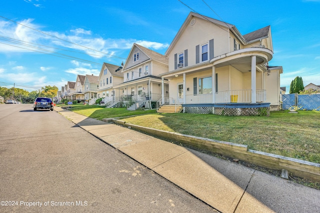 view of front of property with a front lawn and covered porch