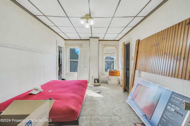 bedroom with carpet floors and a drop ceiling