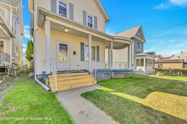 view of front of property with covered porch and a front yard