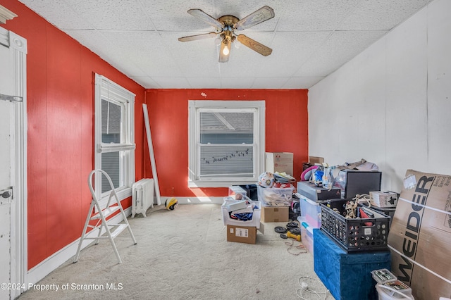 misc room with light carpet, a drop ceiling, and ceiling fan